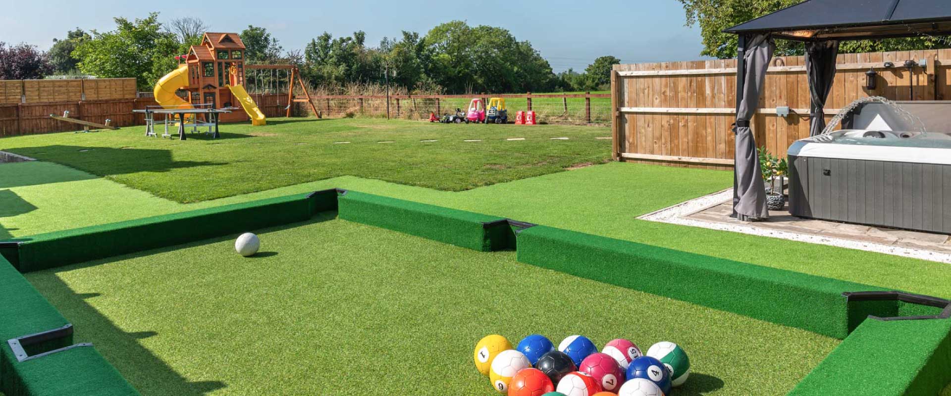 Large garden featuring a football pool table, children's playground, and a luxury hot tub.